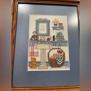 Framed Cross-Stitch Art country blue cottage core teddy bear, basket, doll 8x10”